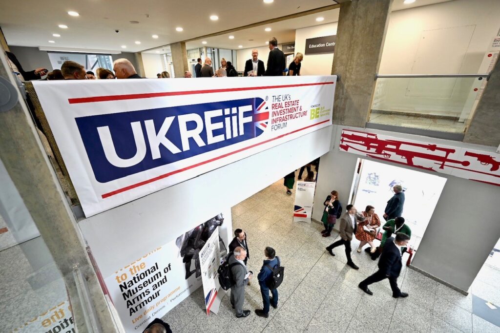 People standing around and networking at the UKREiiF event